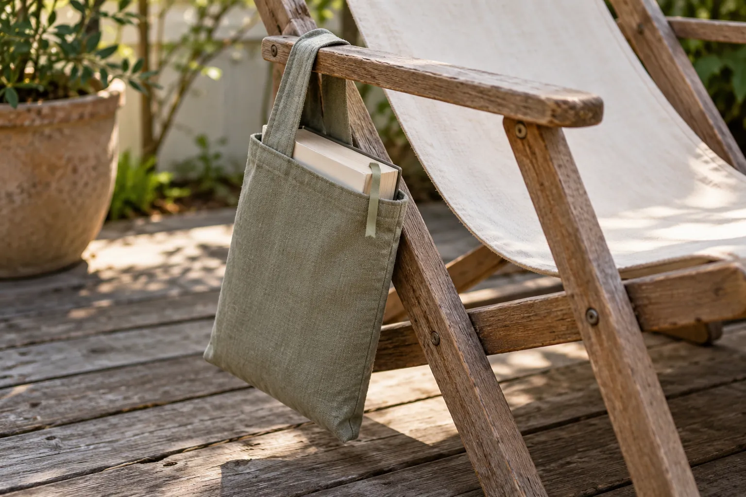Illustration: A paperback in a cloth sleeve hanging from an empty canvas deck chair.
