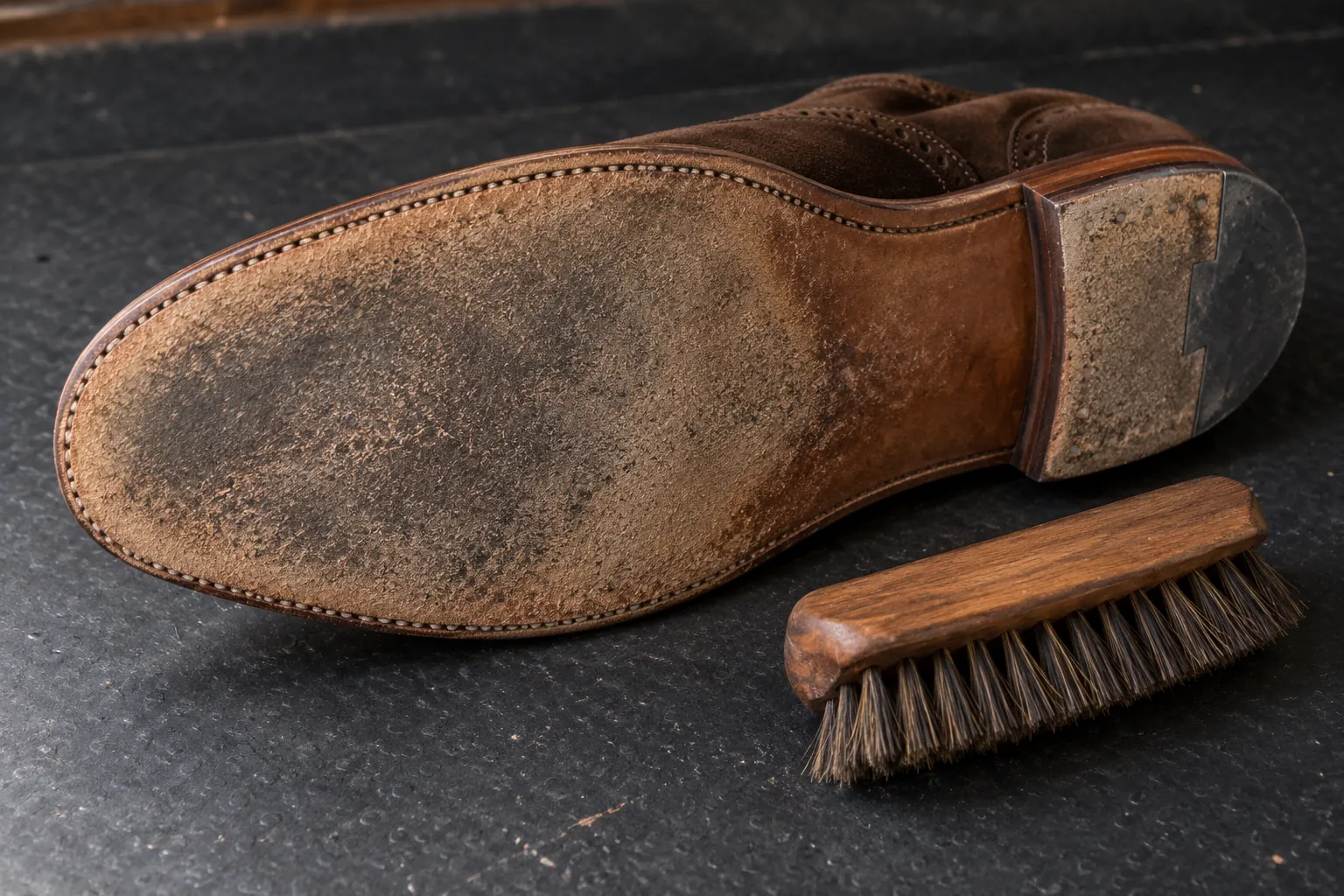 Illustration: A worn suede dance sole beside a small shoe brush.