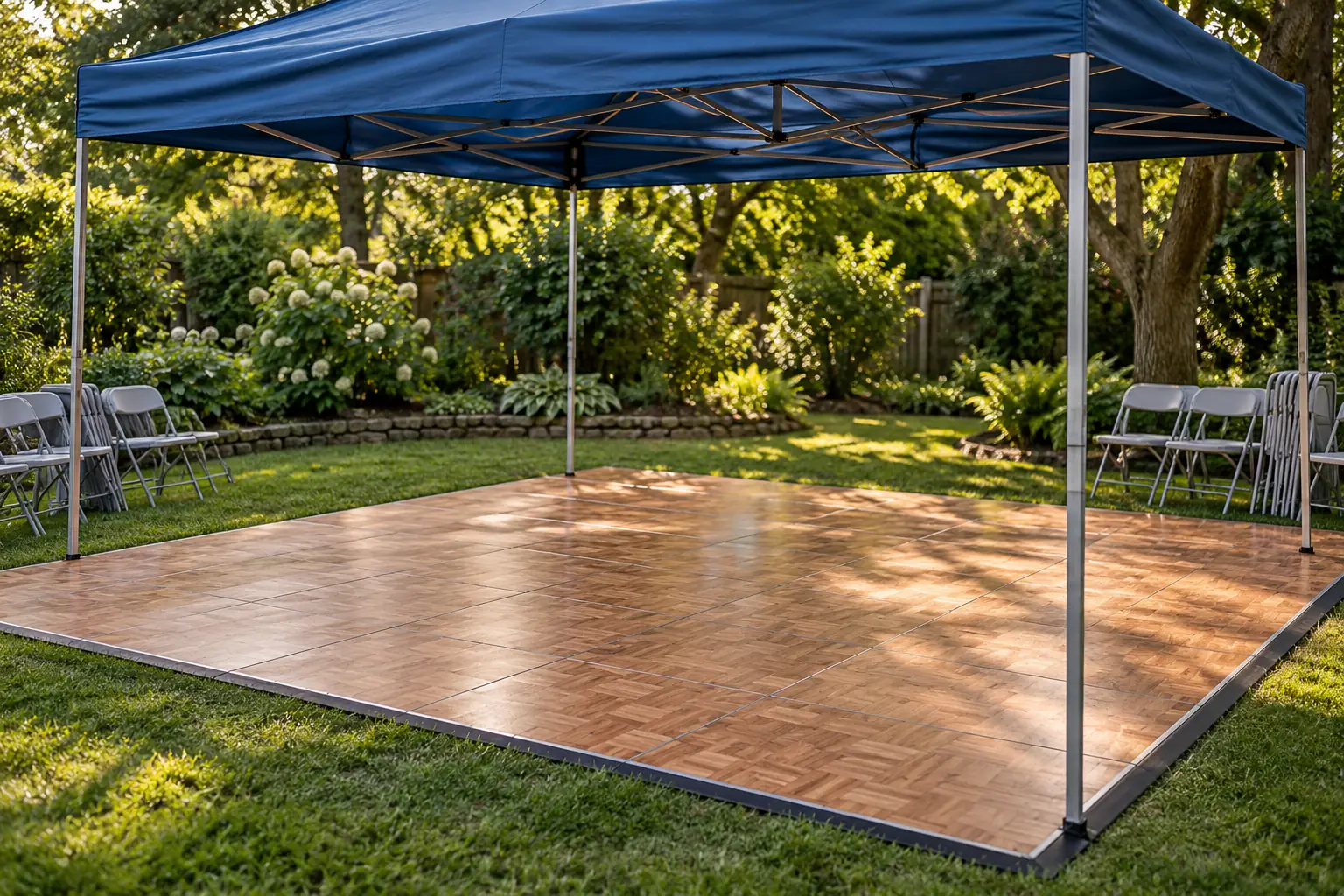 Illustration: A modest interlocking dance floor waits under a blue canopy in an empty garden, with folded chairs around the edges and soft afternoon shadows.