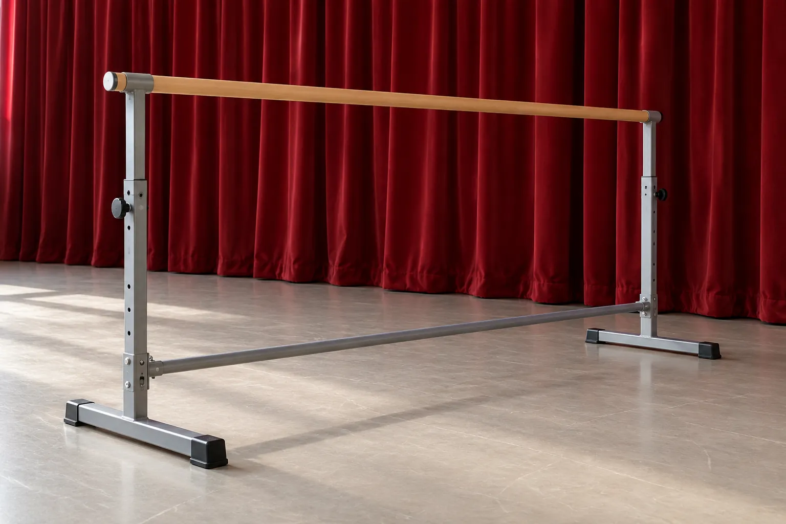 Illustration: A portable metal practice barre stands before a deep red curtain on a pale studio floor, seen in a wide diagonal composition with believable construction.