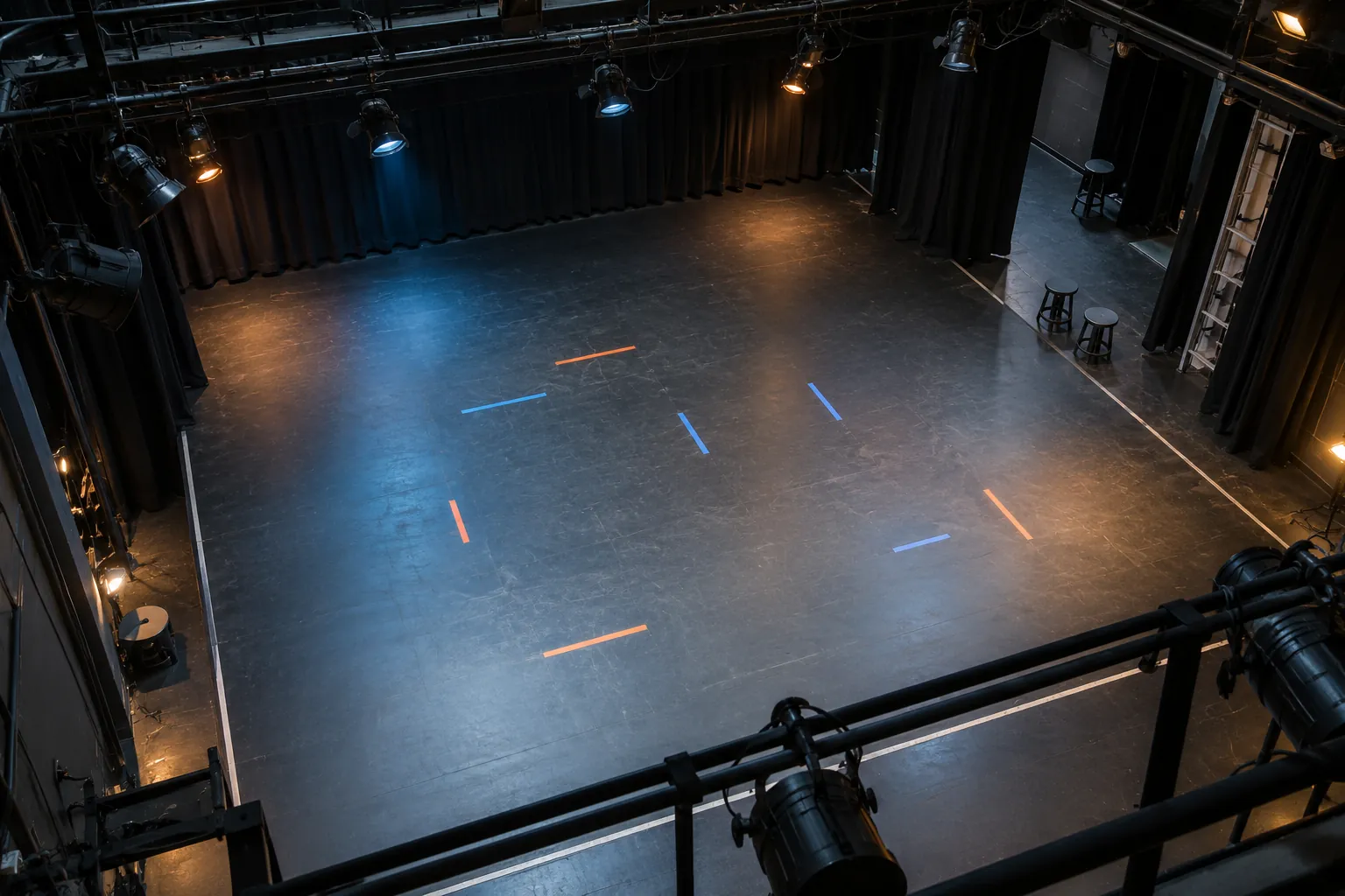 Illustration: Colored blocking tape on an empty stage viewed from above.