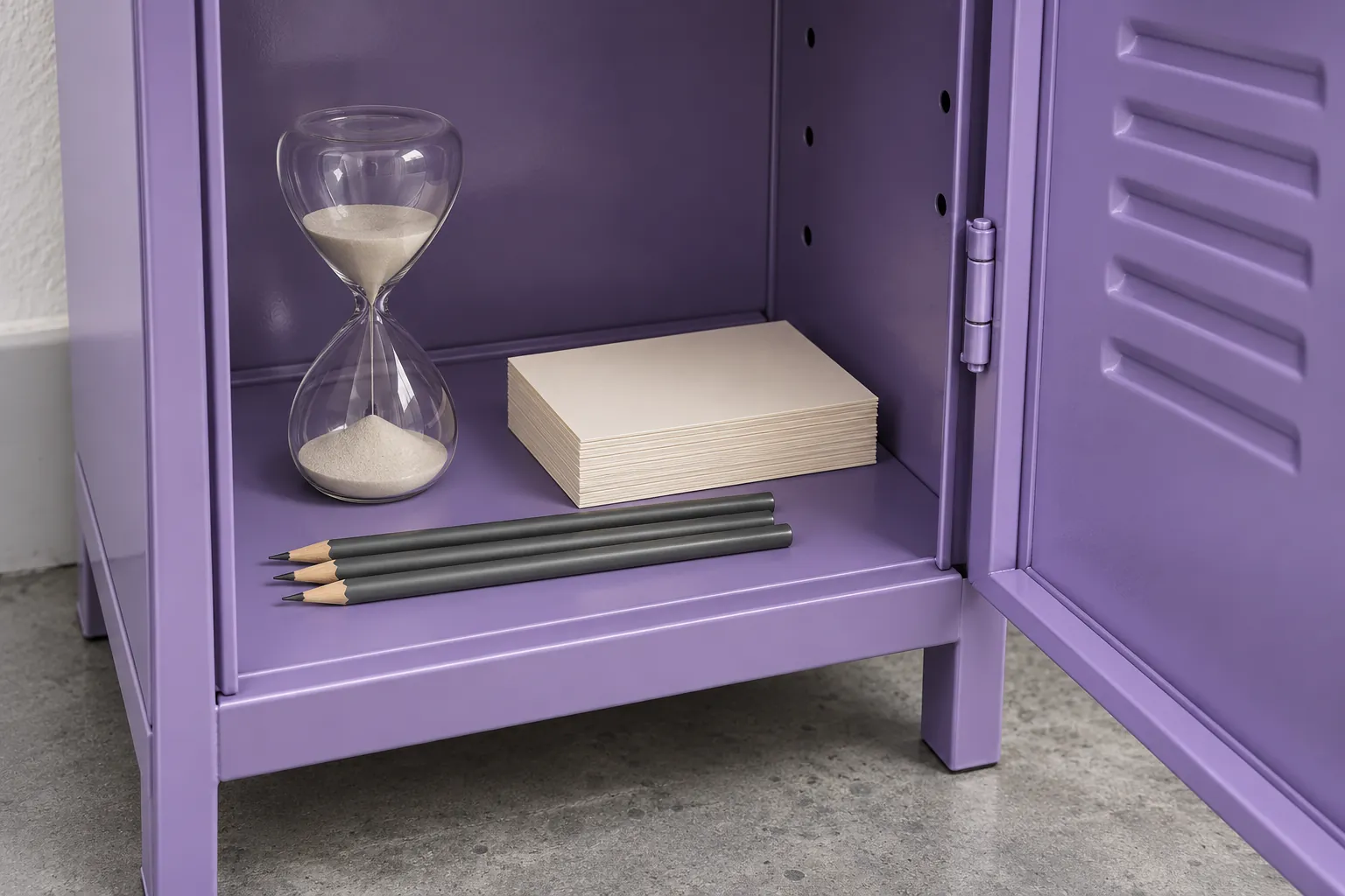 Illustration: A simple sand timer, blank cards and unmarked pencils in a small open violet locker above a grey floor.