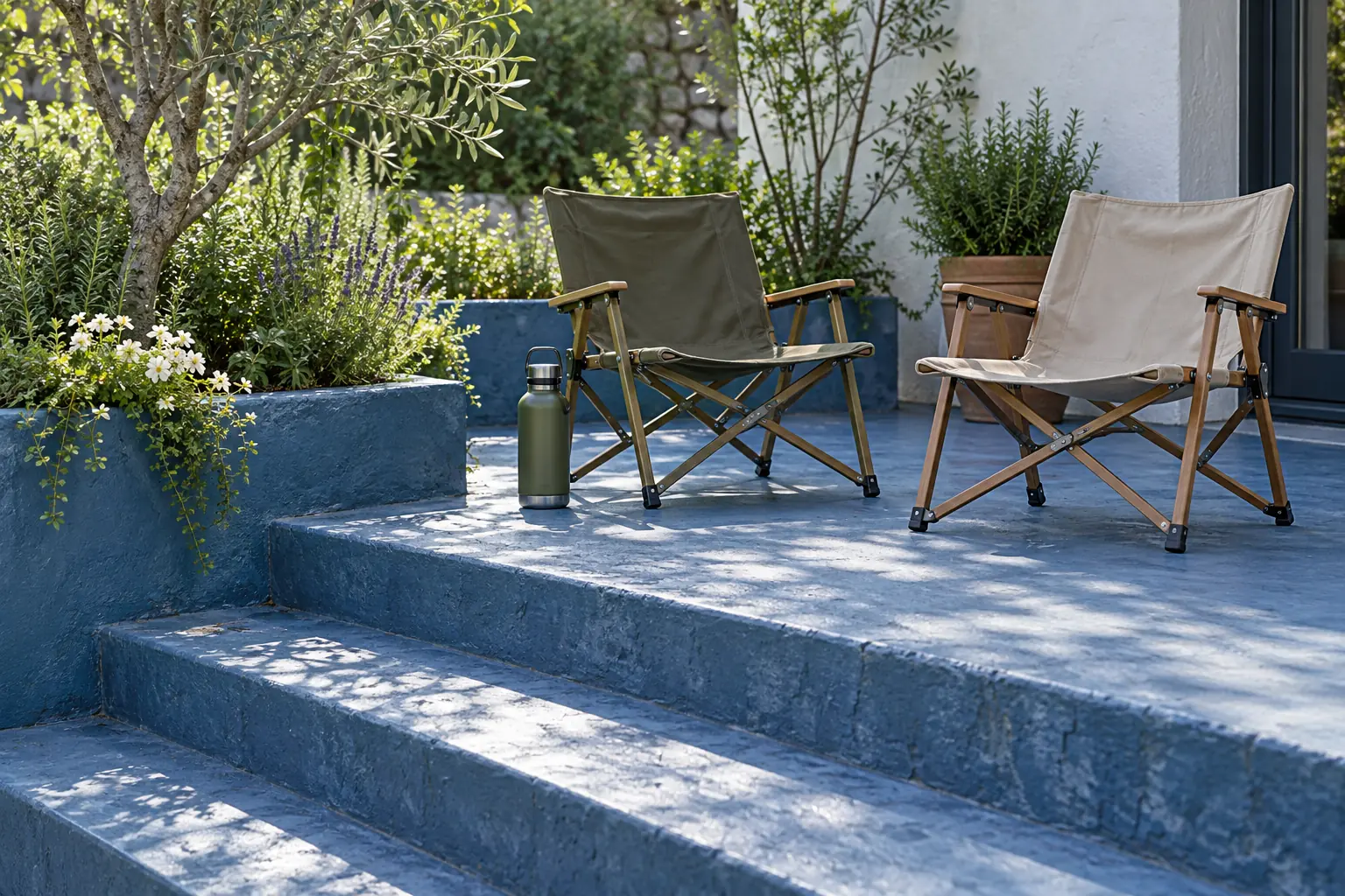 Illustration: Two canvas camp chairs and a water flask occupy a broad blue-painted outdoor stair landing beside a small garden, viewed diagonally.
