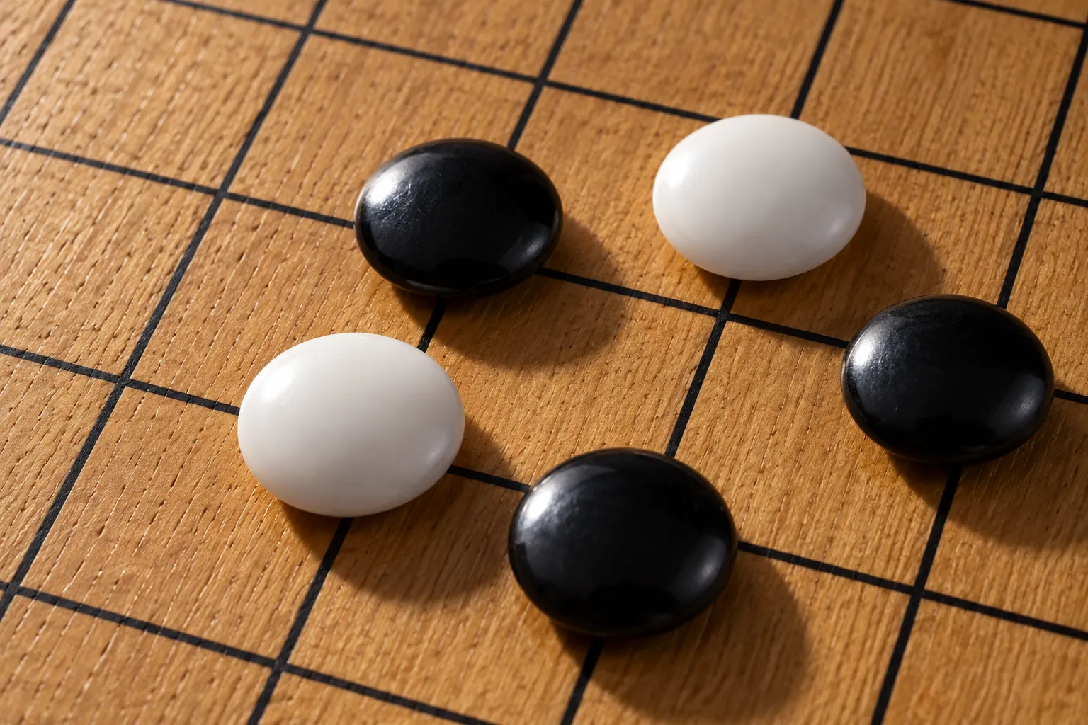 Illustration: Black and white Go stones placed on grid intersections.