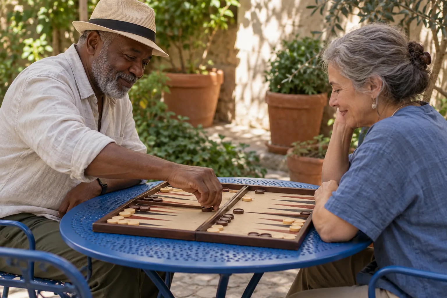 Illustration: Two older adults play backgammon at a cobalt metal courtyard table with a plain triangular-point board.