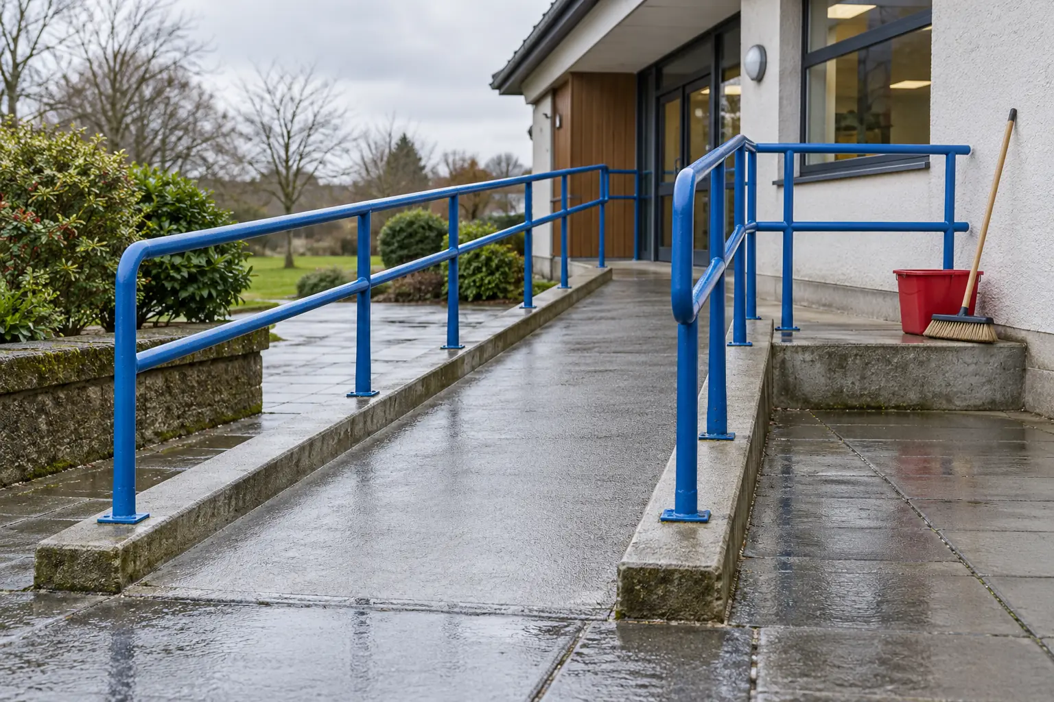 Illustration: Cleaning equipment beside an empty community-building accessibility ramp.